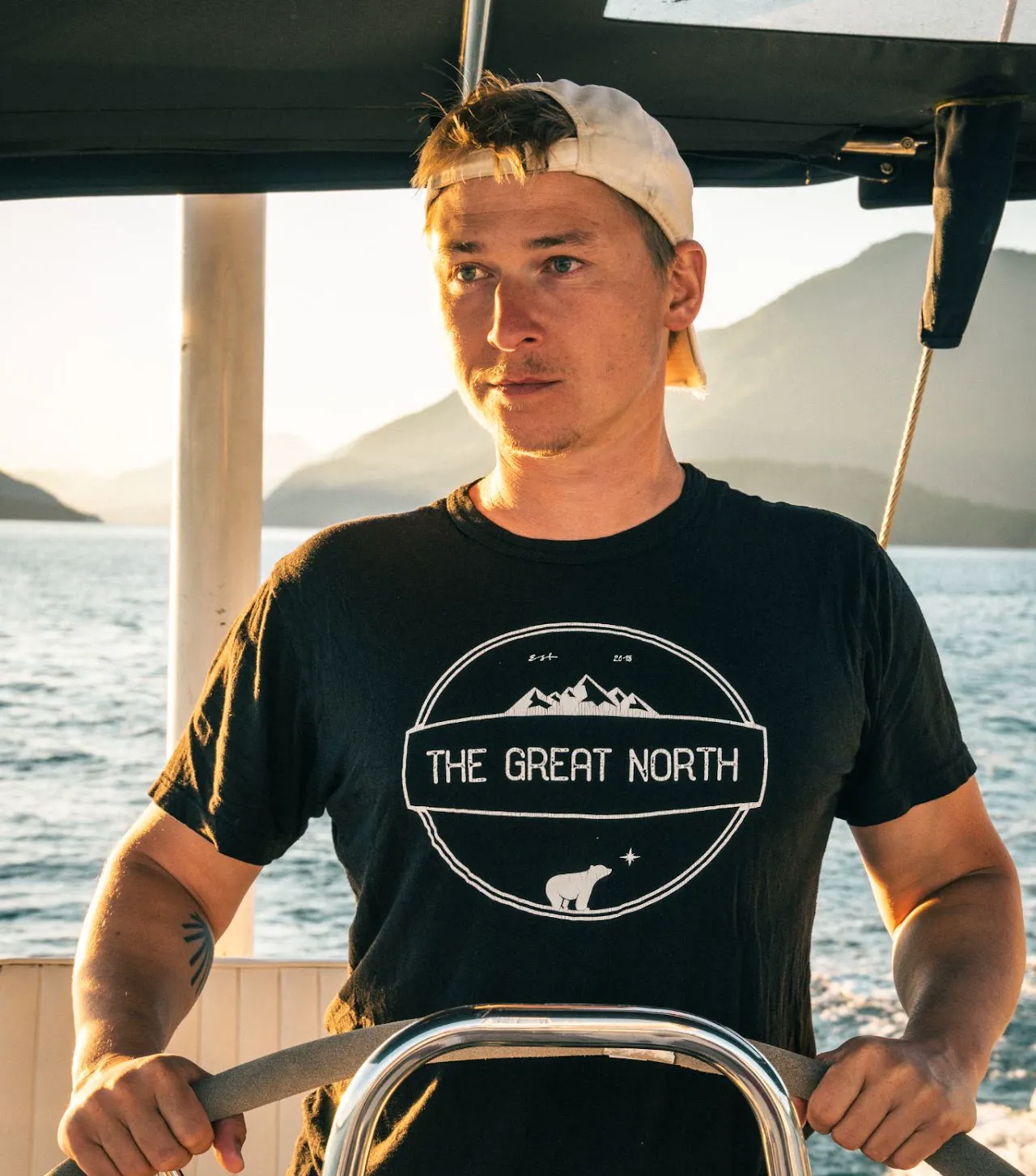 Patrik at the helm of a sailboat